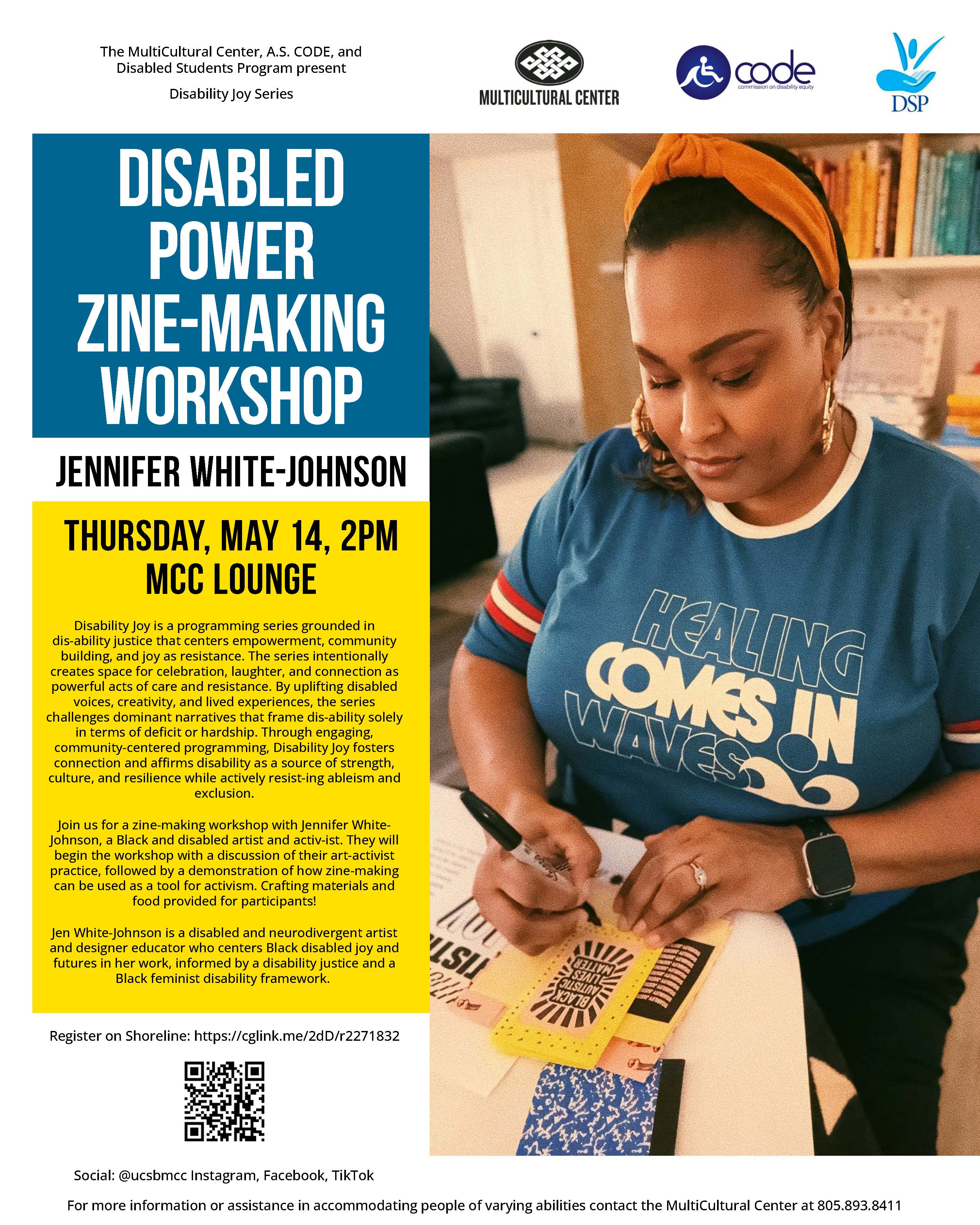 Woman in colorful tshirt that has a graphic of colorful hands meeting to form a sqaure shapewith a bandana in her hair and large gold earrings looking at the camera in a white room with full bookshelves and a banner on the wall thatsays create and resist 